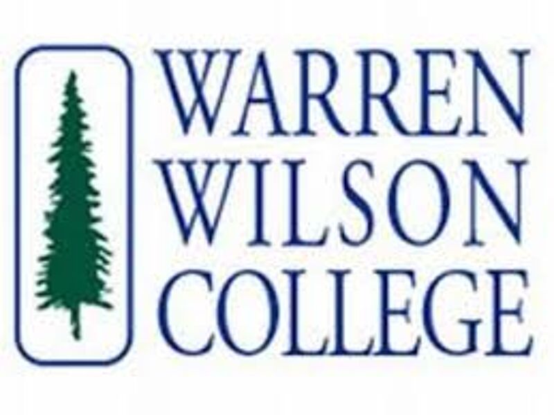 The image displays the logo for Warren Wilson College. The logo features the college's name in bold, blue text, stacked in three lines: "WARREN," "WILSON," and "COLLEGE." To the left of the text is a vertical rectangle containing a green pine tree. The overall design is clean and professional, reflecting the college's brand identity.